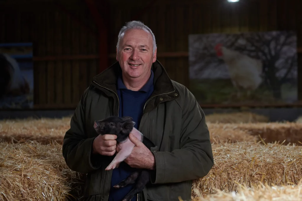 Man holding piglet