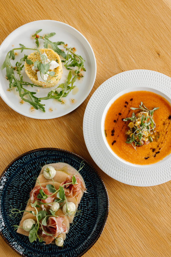 Three vibrant summer dishes on a table