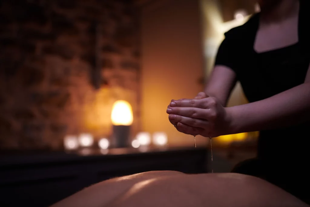 Hands dripping oil as part of a massage