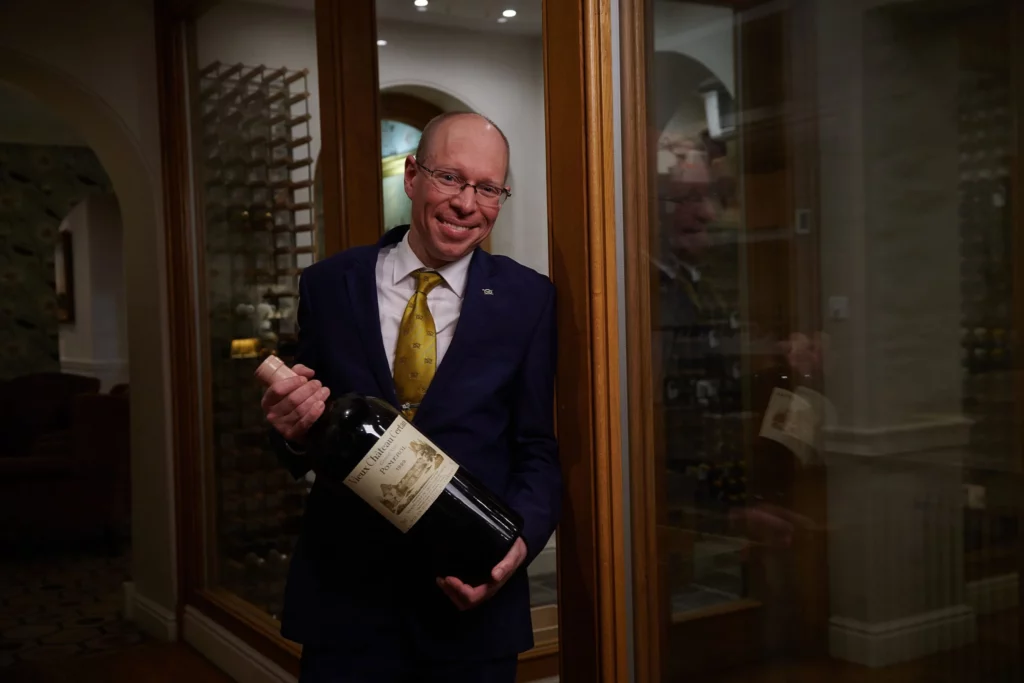 Sommelier holding a large bottle of wine
