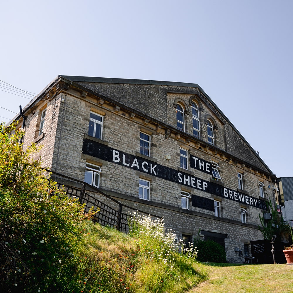 The black sheep brewery building is an old stone factory.