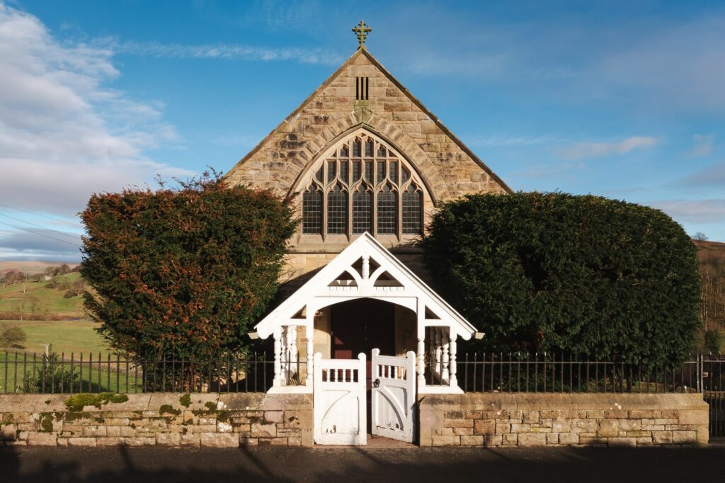 Wesleyan Cottage with its original chapel exterior and swing gate.