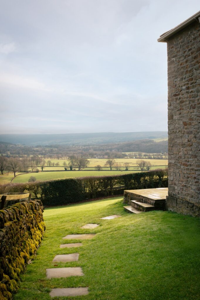 Stepping stone view through the garden with view of the rolling valley.