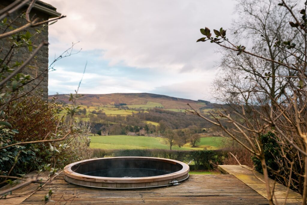 Steaming and bubbling hot tub with a picturesque view of the rolling valley.