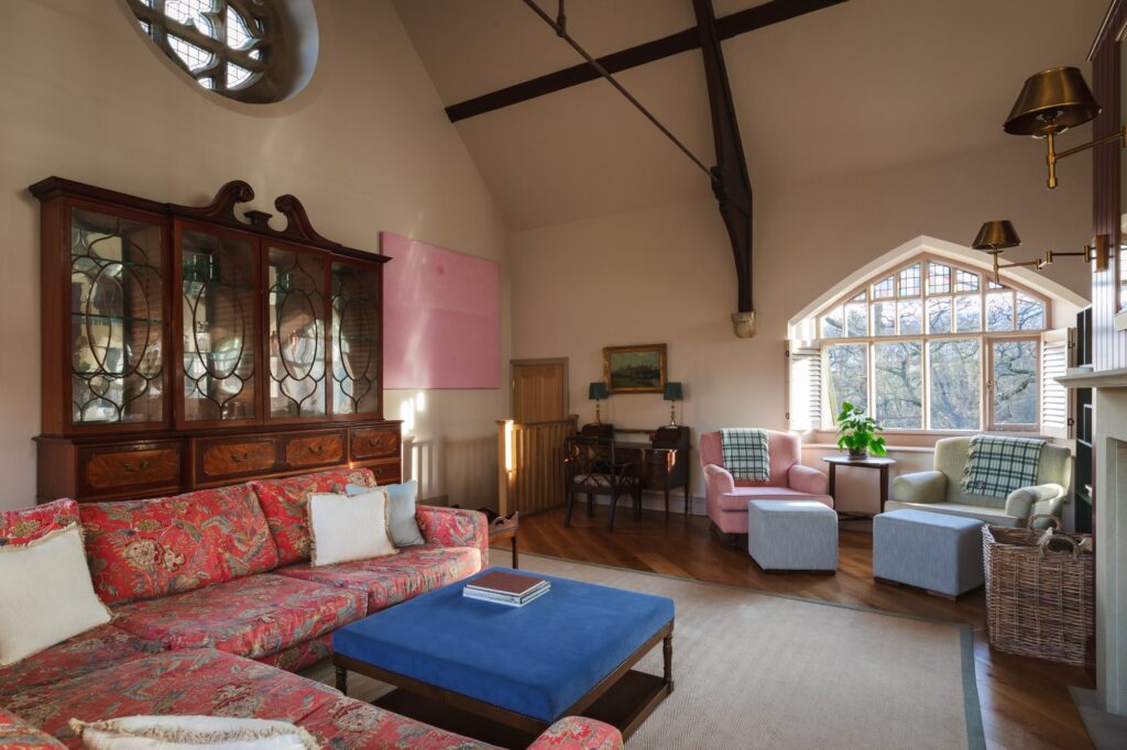 Antique furnishings in the living room, with high open ceilings and rustic beams.