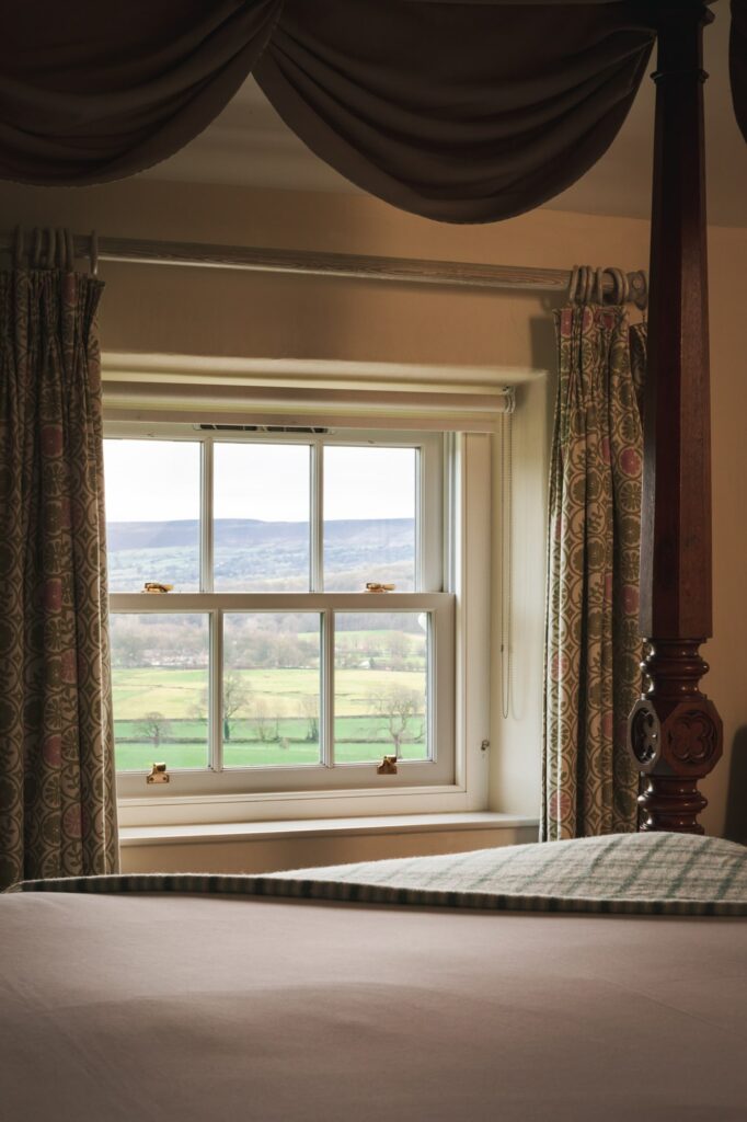 View from the bed towards the valley, with the bed framing the window.