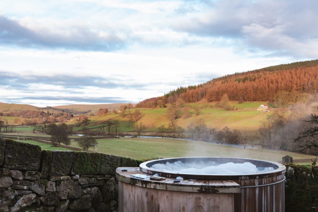 A steaming and bubbling hot tub overlooking the picturesque view of the valley bellow.