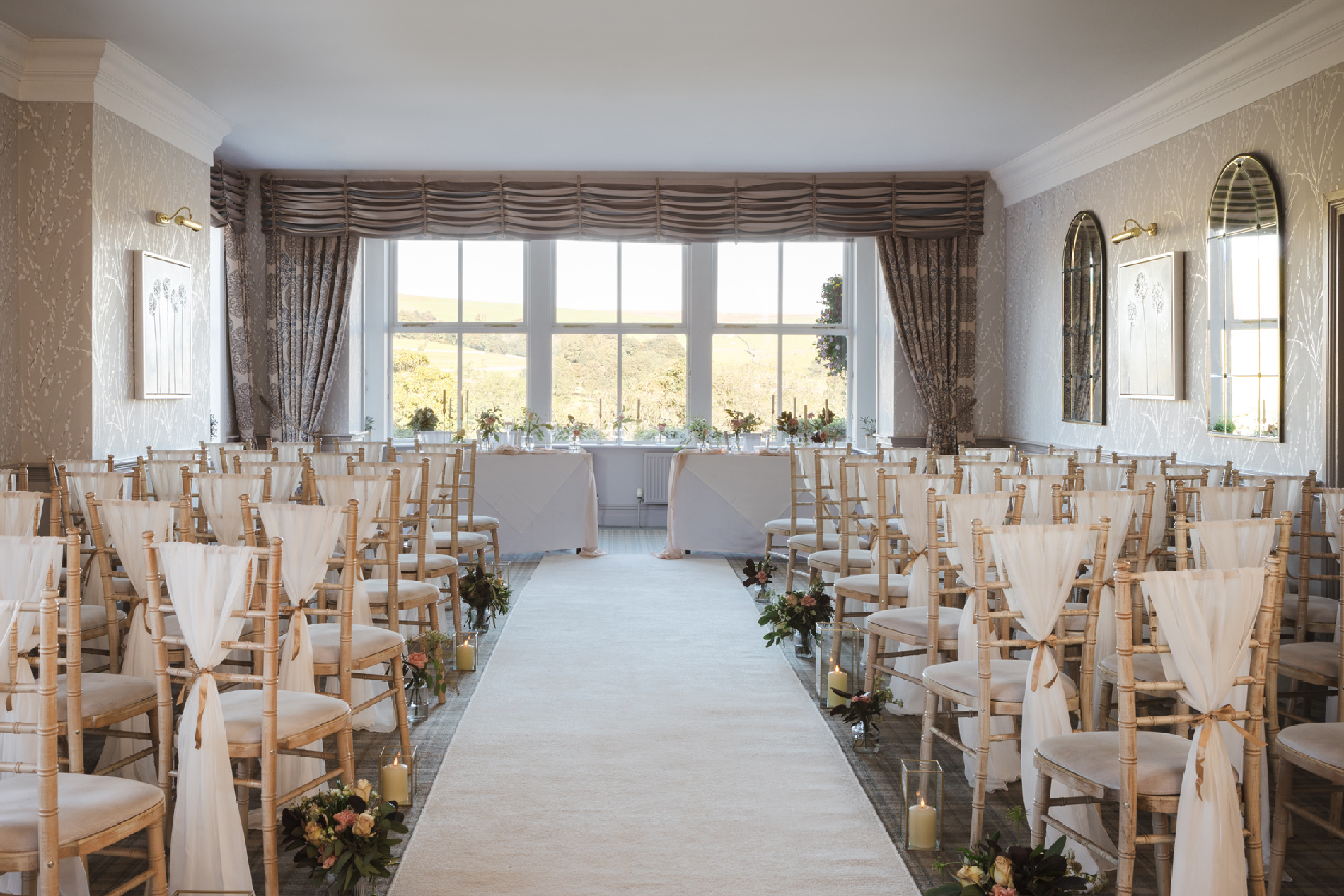 A large room with chairs lined up with an aisle down the middle