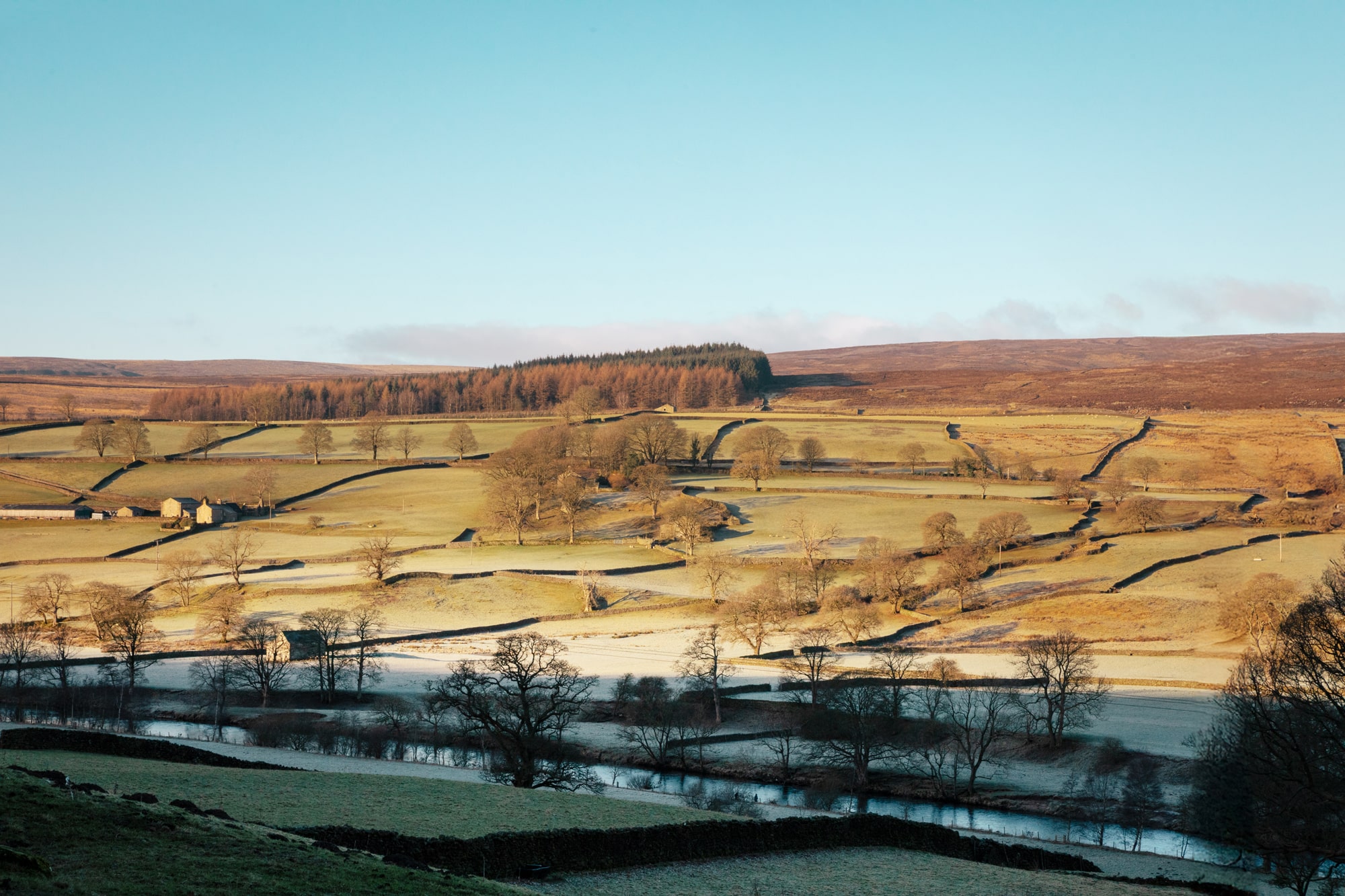 The frosty yorkshire landscape with rolling fields and forests.