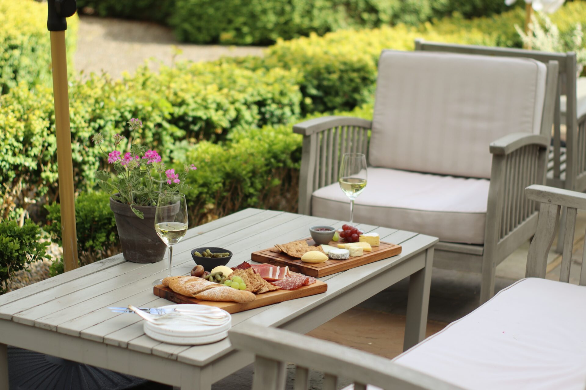 Table and chairs outside with charcuterie