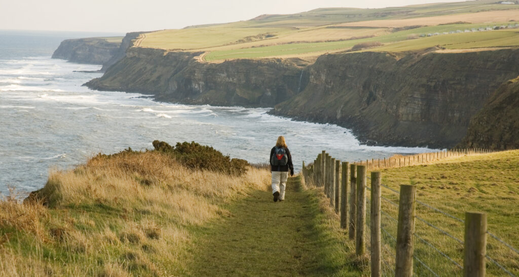 Walker on the coastal path, the Cleveland way in North Yorkshire, England, UK.
