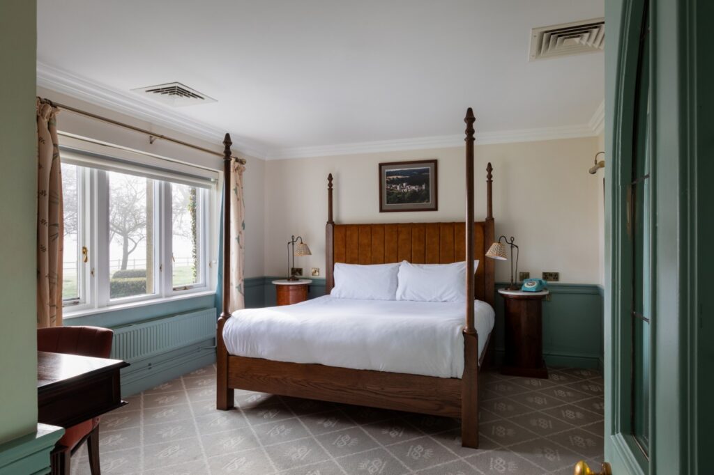 Four poster bedroom with views out to trees