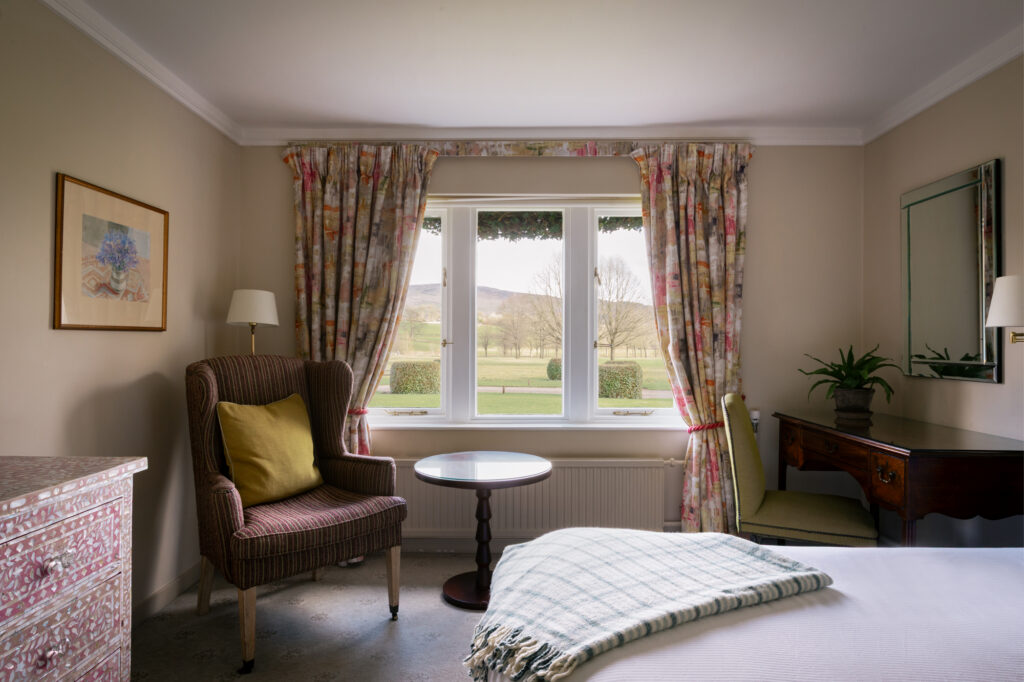 Comfortable bedroom with views out to green fields
