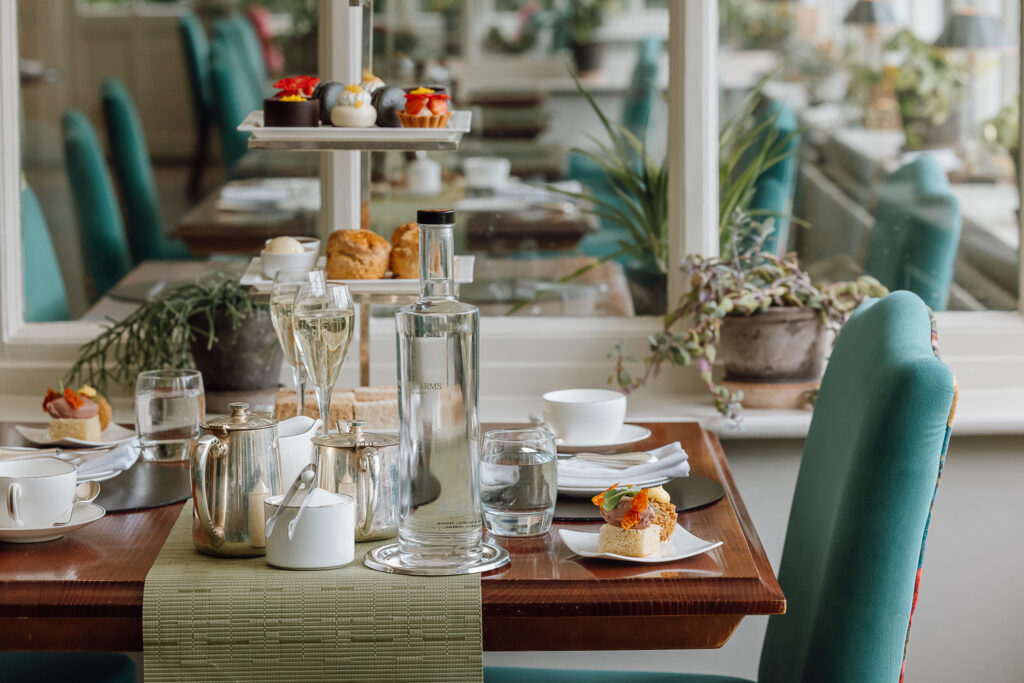 A luxurious afternoon tea stand in The Garden Room filled with sandwiches, sweet treats and scones.