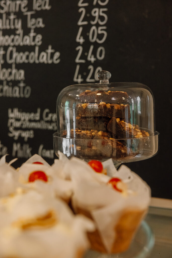 Bakewell muffins and chocolate brownies sit in stands on the counter at Strid Wood Tea Rooms